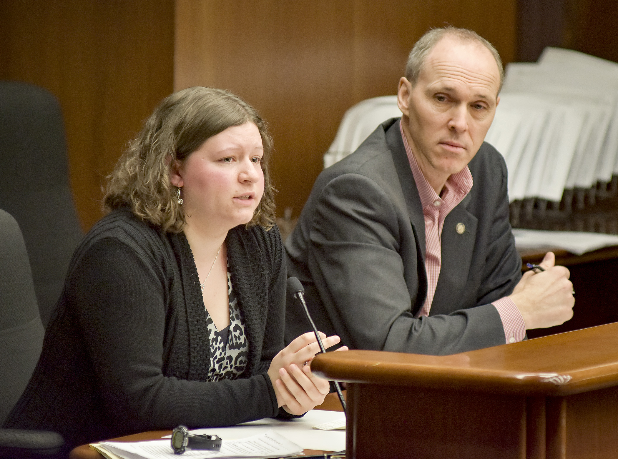 Kayla Meyer testifies before the House Health and Human Services Reform Committee March 7 in support of a bill sponsored by Rep. Rod Hamilton, right, that would improve the implementation of youth sports concussion protocols and identify best practices for preventing and treating concussions. Photo by Andrew VonBank